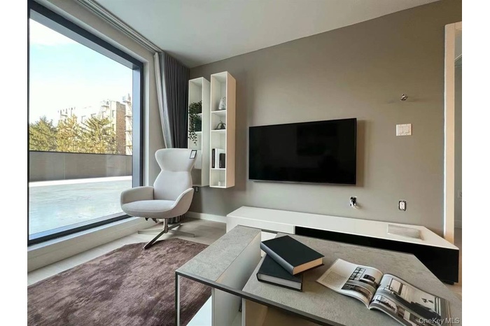 Living area featuring an office area and baseboards