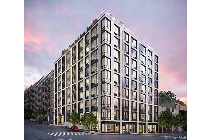Property at dusk with a view of apartment building / complex