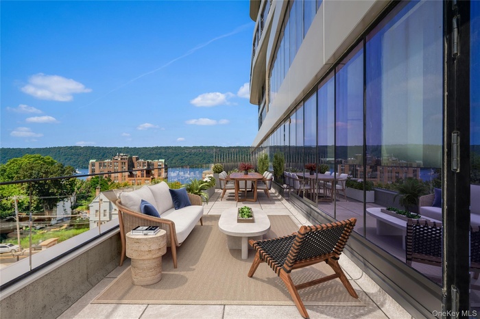 Balcony with an outdoor hangout area, a view of trees, and outdoor dining area