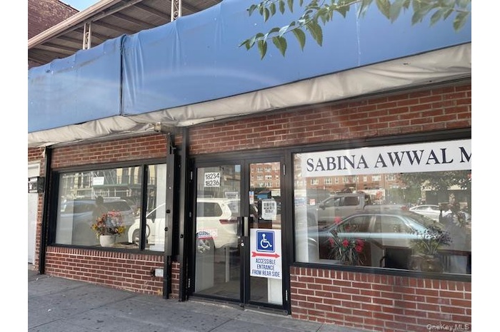 Entrance to property featuring brick siding