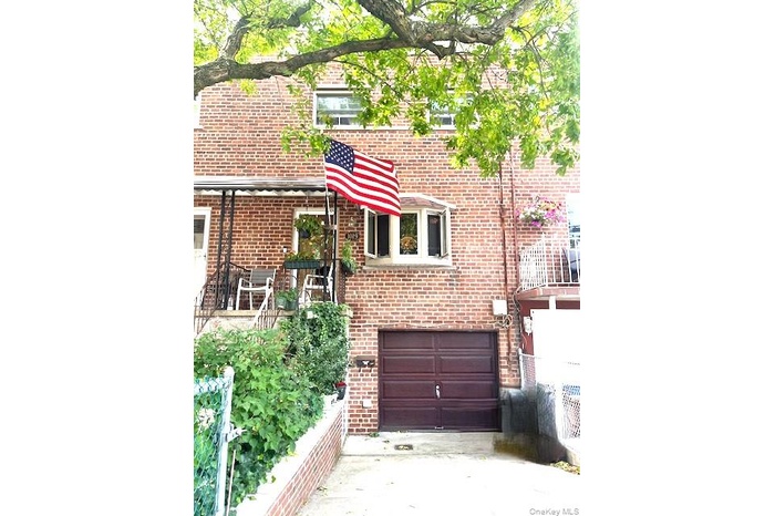View of front facade with brick siding, an attached garage, and concrete driveway