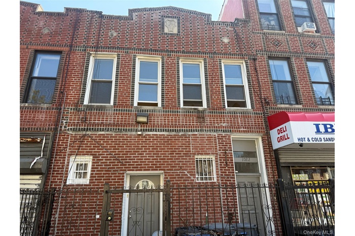 View of building exterior featuring a fenced front yard