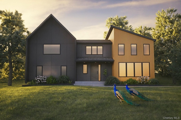 Rear view of house featuring a lawn