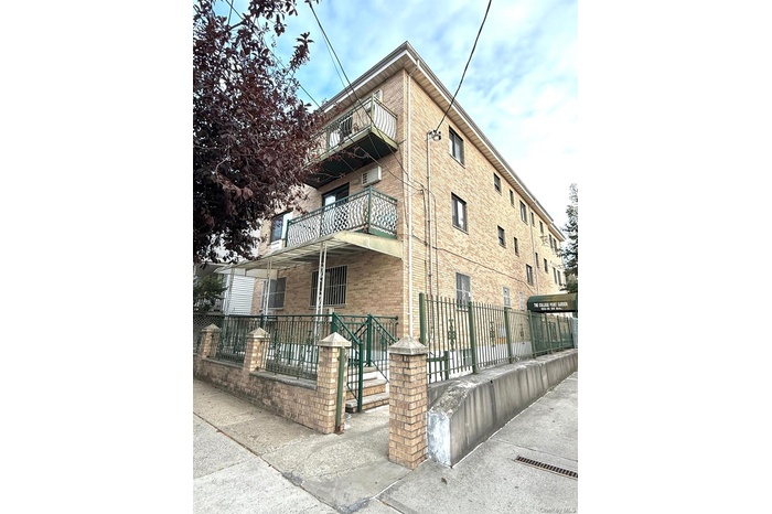 View of building exterior with a fenced front yard
