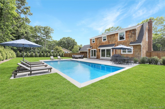 View of pool with a patio and a fenced backyard