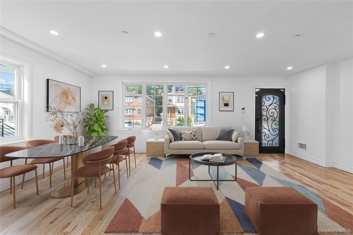 Living area with recessed lighting and light wood-type flooring