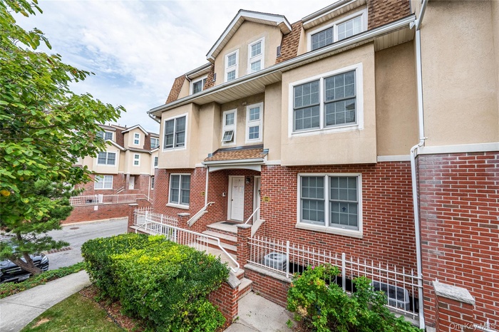 Traditional-style home with stucco siding and brick siding