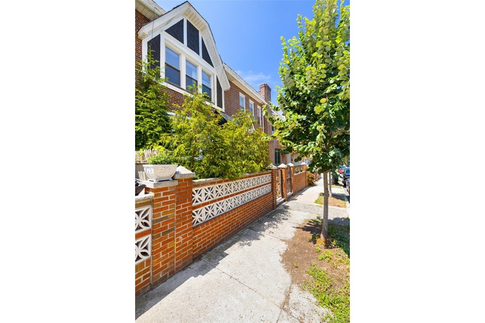 View of home's exterior featuring brick siding and a gate