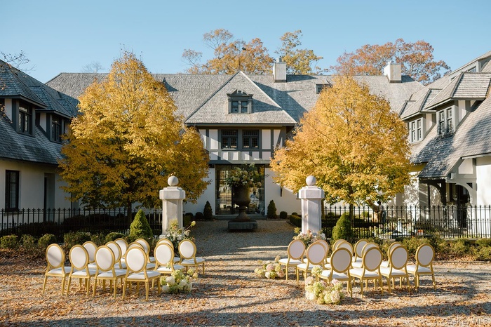 English style home with stucco siding and a chimney