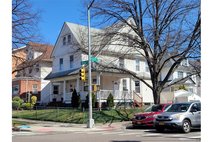 View of front of home featuring a residential view, a front yard, and a fenced front yard