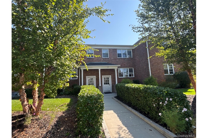 View of front of house featuring brick siding and a porch