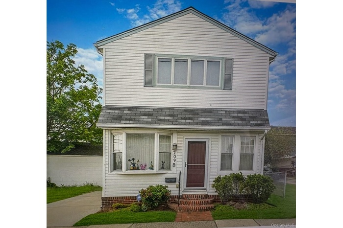 View of front of property featuring a shingled roof