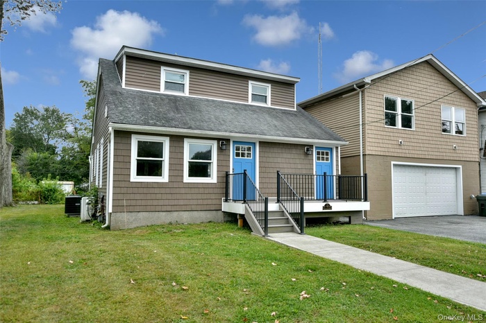 Front view of duplex and detached 2-car garage with large office above