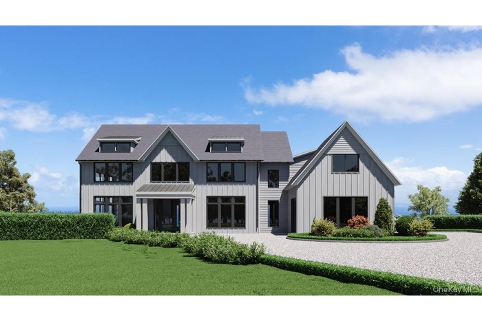 View of front of property featuring board and batten siding and a front yard