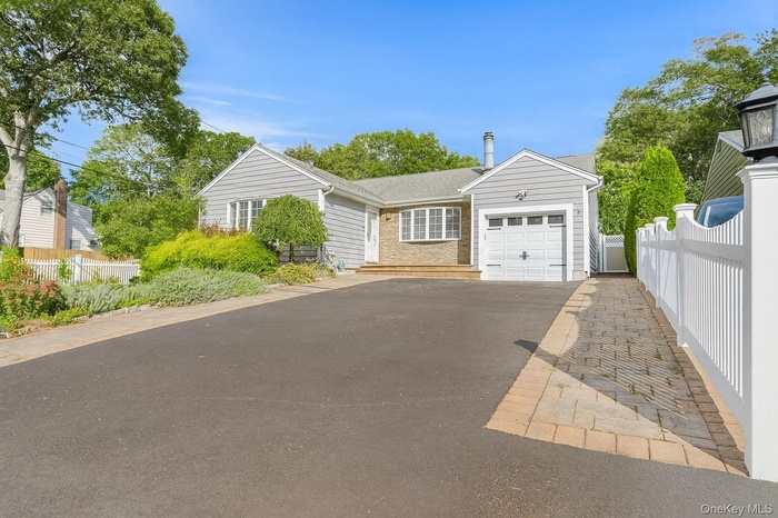 View of front of home featuring a garage and driveway