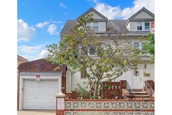 View of front of property with roof with shingles and a fenced front yard