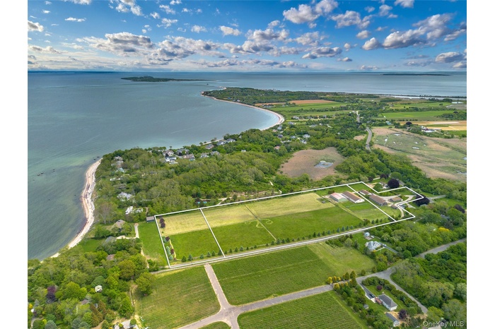 Aerial overview of property's location featuring property parcel outlined and a large body of water