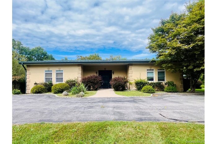 Ranch-style home featuring stucco siding