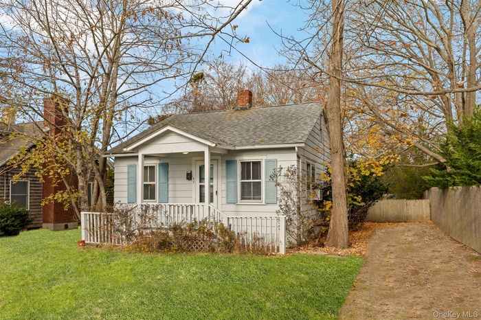 Bungalow-style house with covered porch, a chimney, and roof with shingles