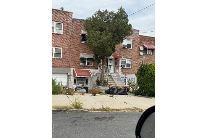 Traditional-style house with brick siding