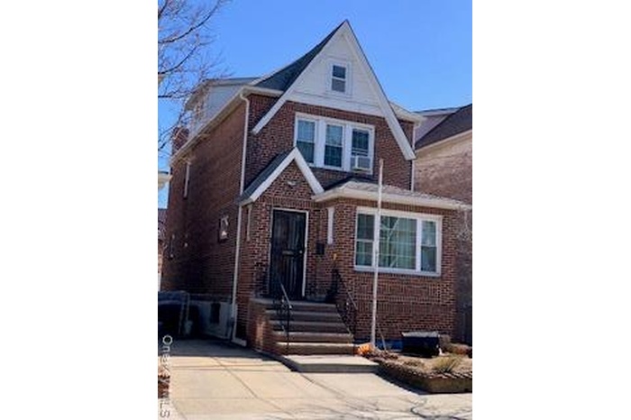 View of front facade with brick siding and driveway