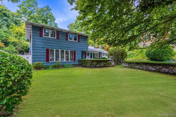 Back of house featuring a yard