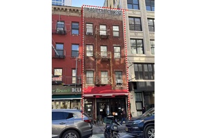 A multi family building with a ground floor retail space, featuring four residential units, located in the heart of Soho.