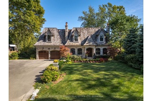 Welcome to 1324 Cambridge Drive, a timeless French inspired custom home that blends classic stone architecture with cedar roofing and flagstone walkways.
