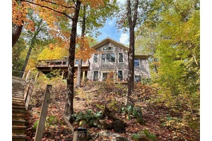 Welcome to your private, custom built retreat nestled in the woods on the shimmering shores of Contau Lake.