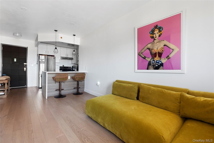 Living area featuring light wood-style flooring and baseboards