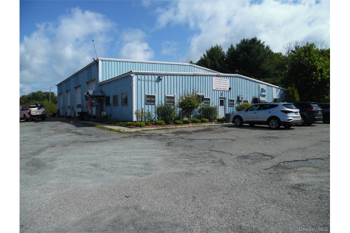 View of property with uncovered parking