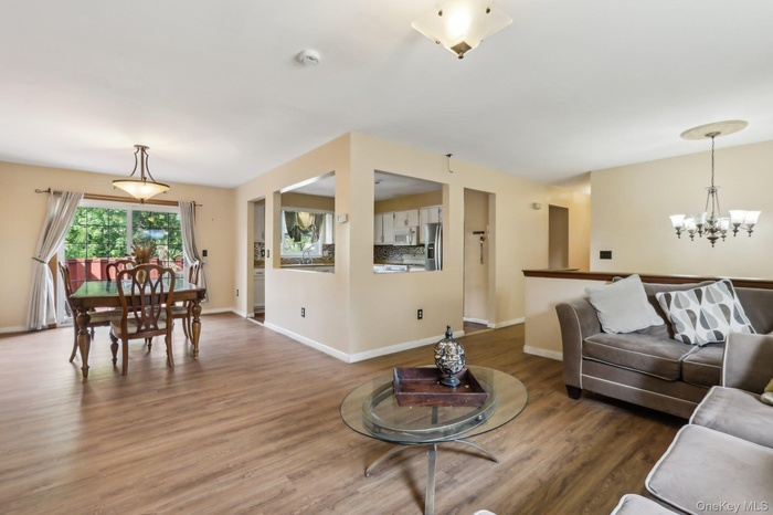 Living Room open to the Dining Room and Kitchen.