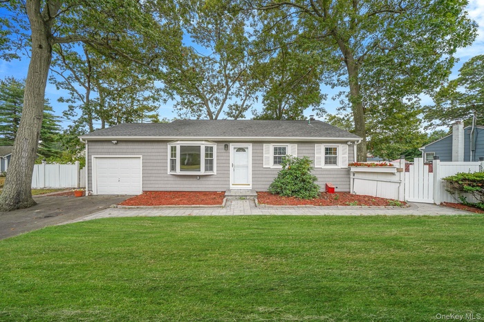 Ranch-style house with driveway and a shingled roof