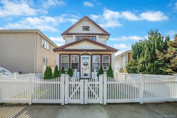 View of front facade with a gate and a fenced front yard