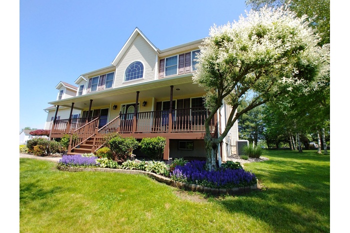 View of front of home with a front lawn and covered porch