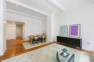 Enjoy true open loft living in this former factory building, defined by nearly 12 foot ceilings and an expansive wall of four towering 7 foot tall windows, granting you a ...