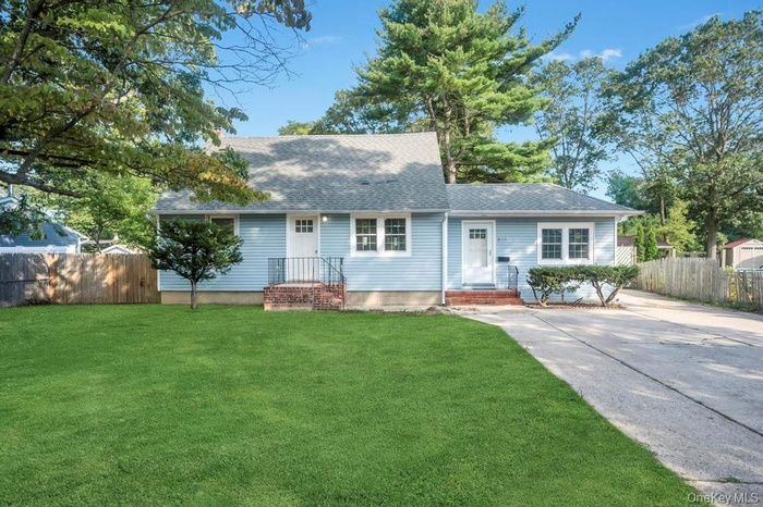 View of front facade with roof with shingles