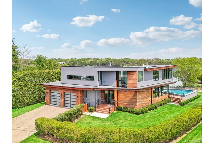 Contemporary house with driveway and a front lawn