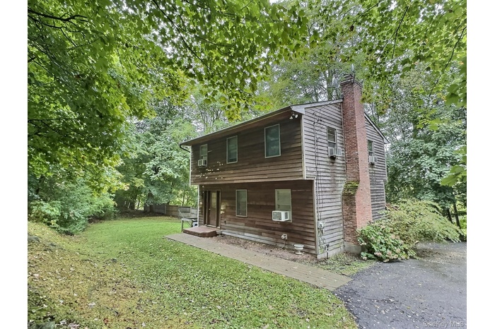 Front of the house down a hill at the end of a cul-de-sac