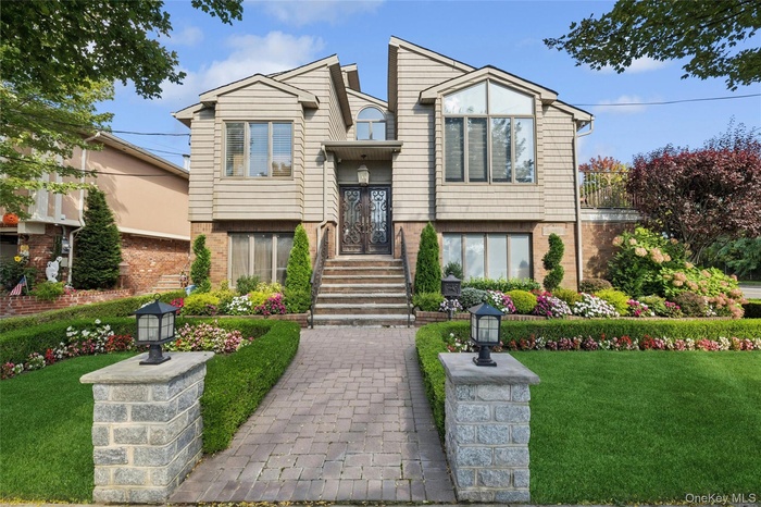 View of front facade with a front lawn and brick siding