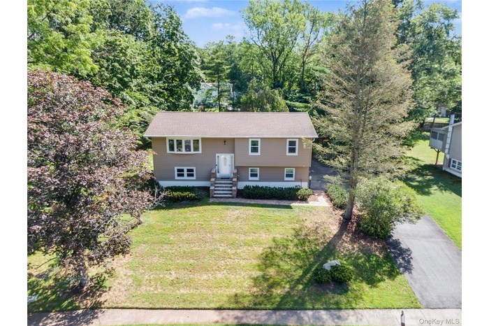 View of front facade with a front lawn and asphalt driveway