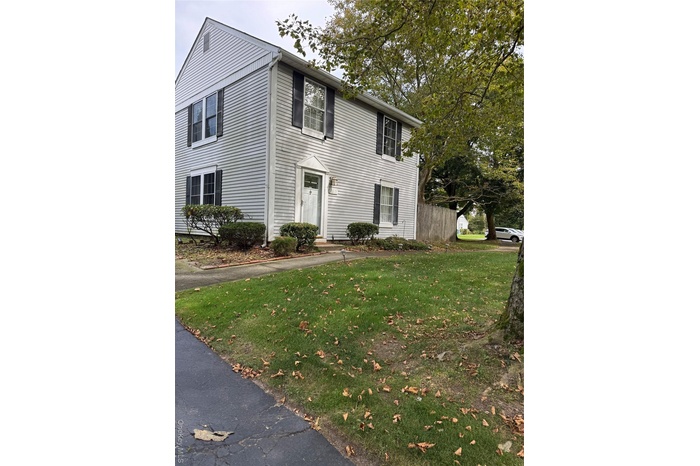 Colonial-style house with a front yard