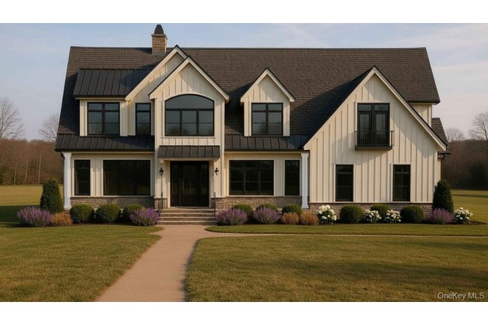Modern farmhouse style home featuring board and batten siding, a front lawn, and a standing seam roof