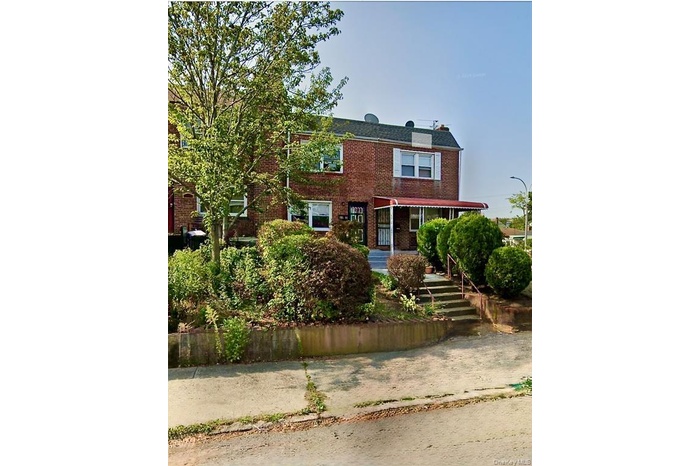 View of front of house featuring brick siding and covered porch