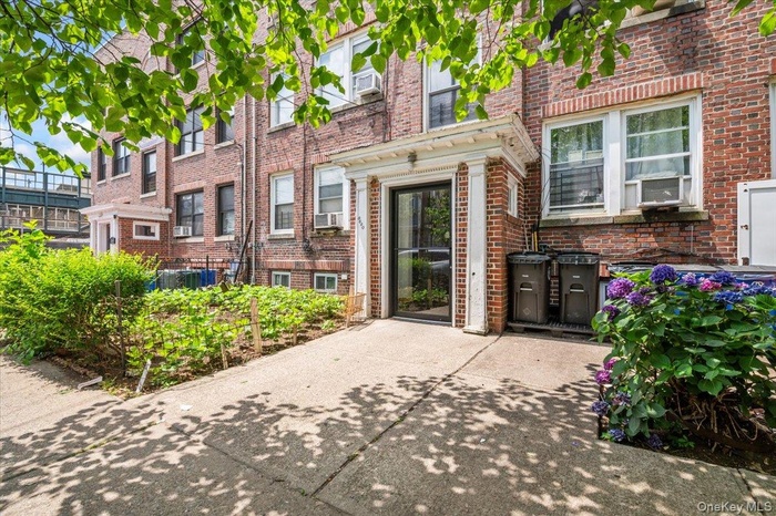 View of exterior entry featuring brick siding