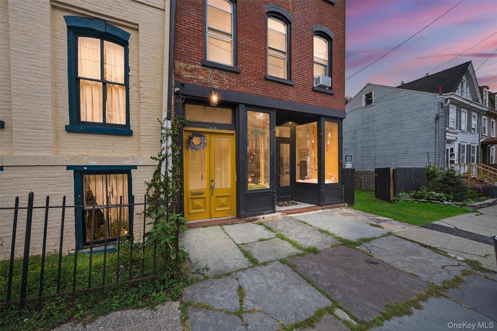 View of exterior entry with brick siding - grass been superimposed (corrected photos to come)