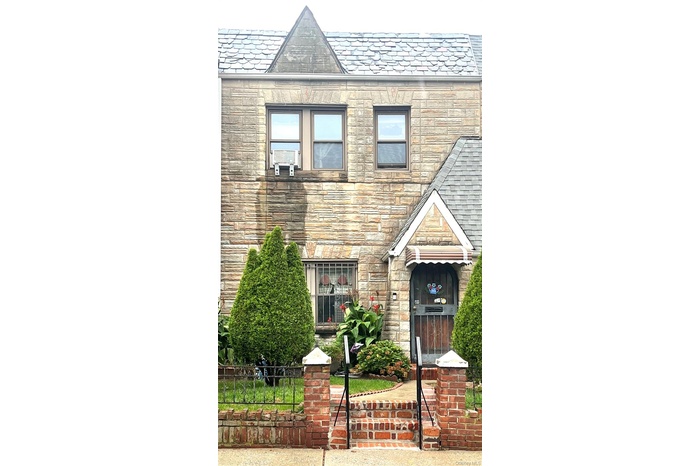 View of front facade featuring a high end roof and stone siding