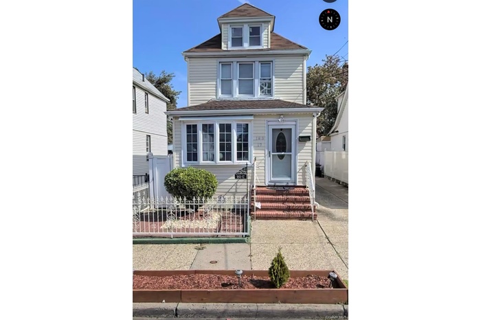Traditional style home with a fenced front yard and a gate