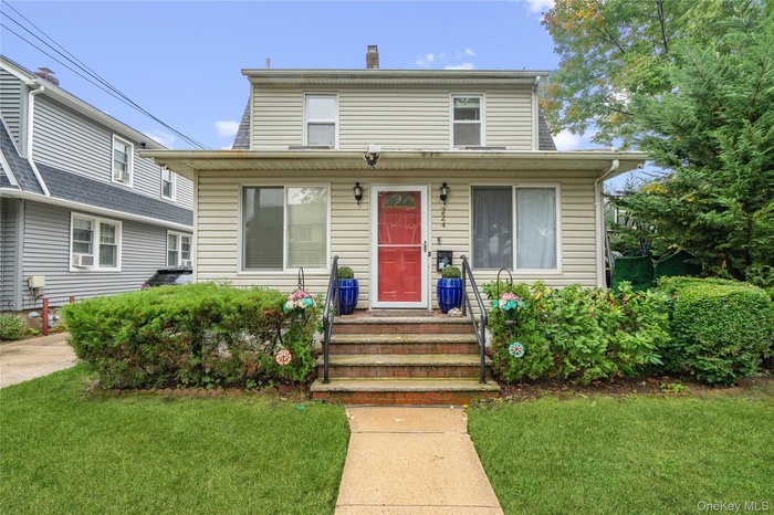 View of front of home featuring a front yard and a chimney