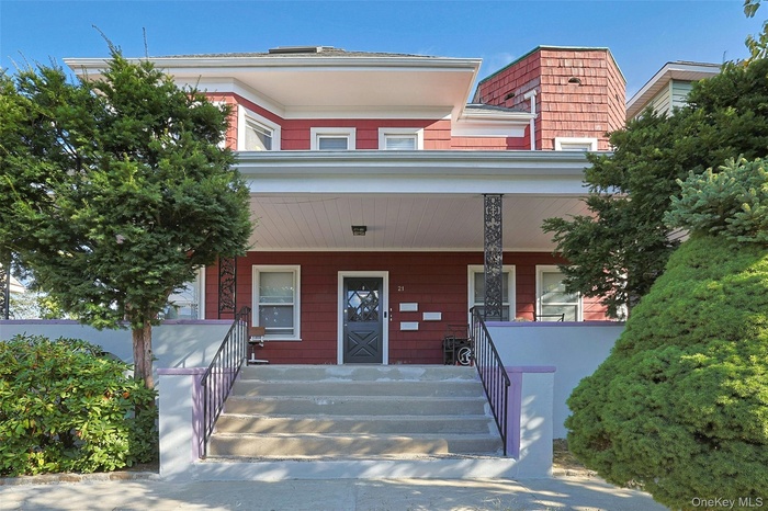 Doorway to property featuring covered porch